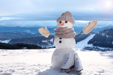 Image of Funny snowman outdoors on sunny day, space for text