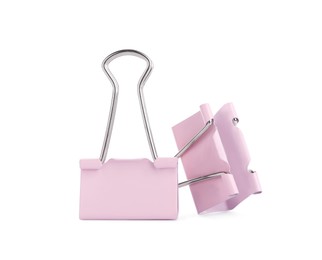 Photo of Pink binder clips on white background. Stationery item