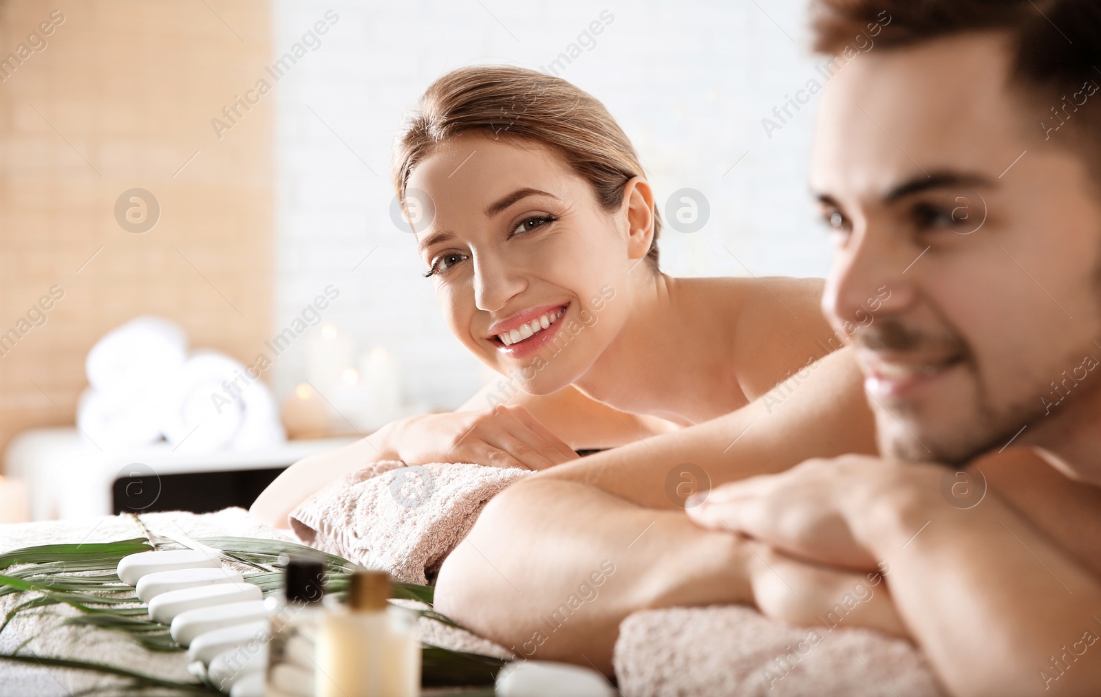 Photo of Romantic young couple relaxing in spa salon