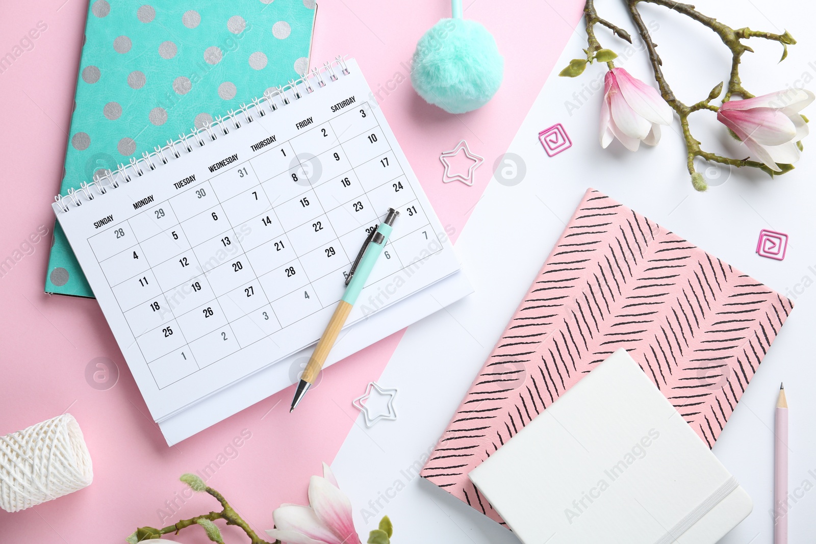 Photo of Flat lay composition with calendar and stationery on color background