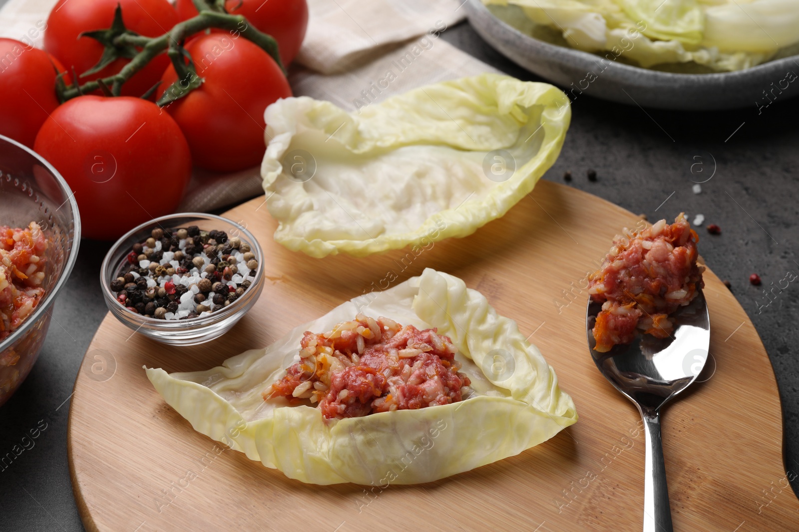 Photo of Ingredients for preparing stuffed cabbage rolls on black table