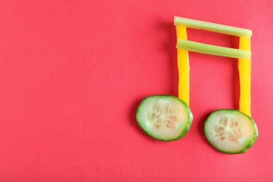 Photo of Musical note made of vegetables on color background, top view. Space for text