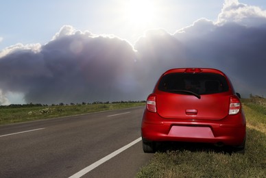 Car on kerb near asphalt road outdoors on cloudy day