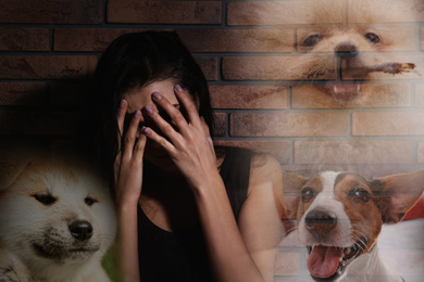 Image of Scared young woman suffering from cynophobia near brick wall. Irrational fear of dogs