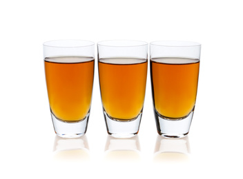 Photo of Three shots with drink isolated on white