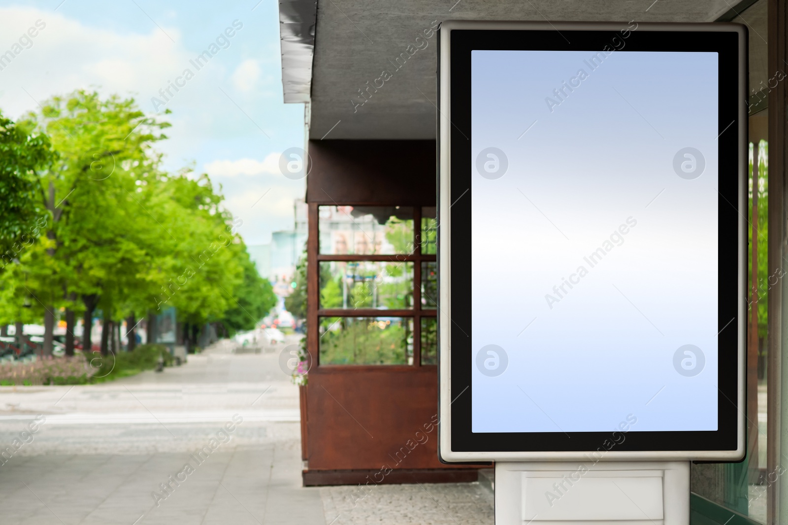 Photo of Blank advertising board on city street. Mockup for design