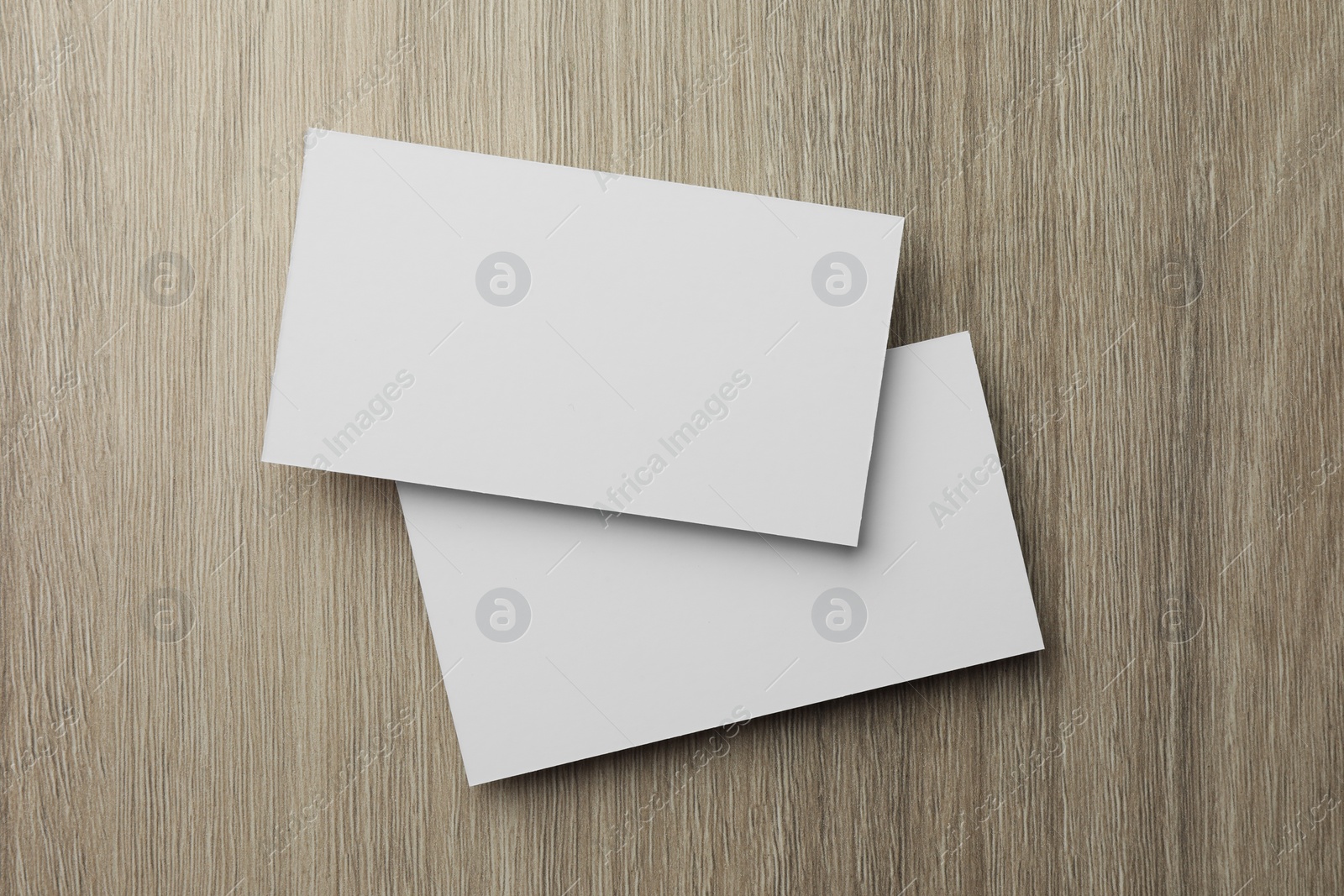 Photo of Blank business cards on wooden table, top view. Mockup for design