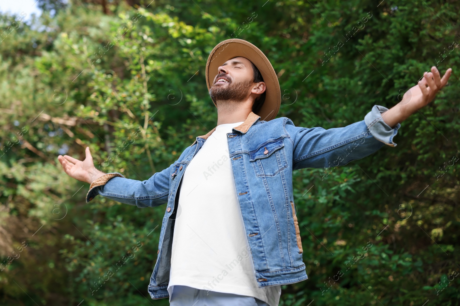 Photo of Feeling freedom. Smiling man enjoying nature outdoors