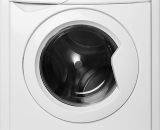 Photo of Modern empty washing machine on white background. Laundry day