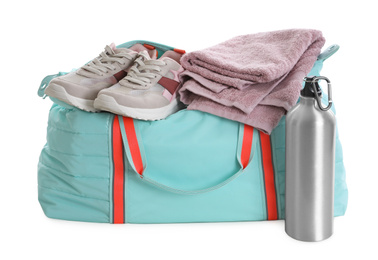 Photo of Sports bag with gym equipment on white background