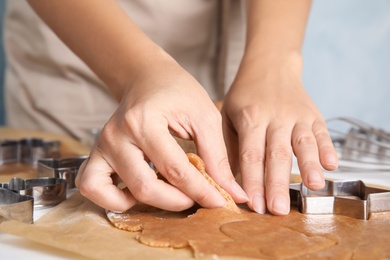 Woman making Christmas cookies at table, closeup