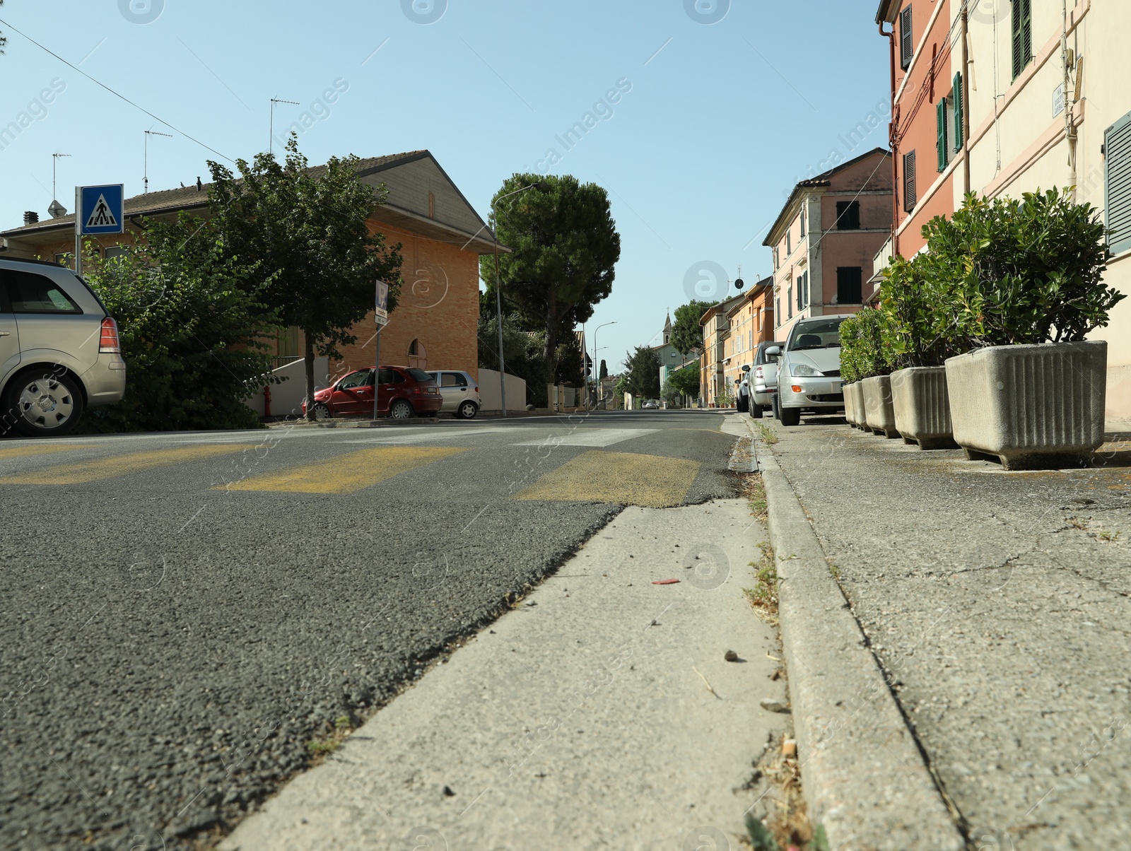 Photo of Many beautiful buildings and cars near crosswalk outdoors