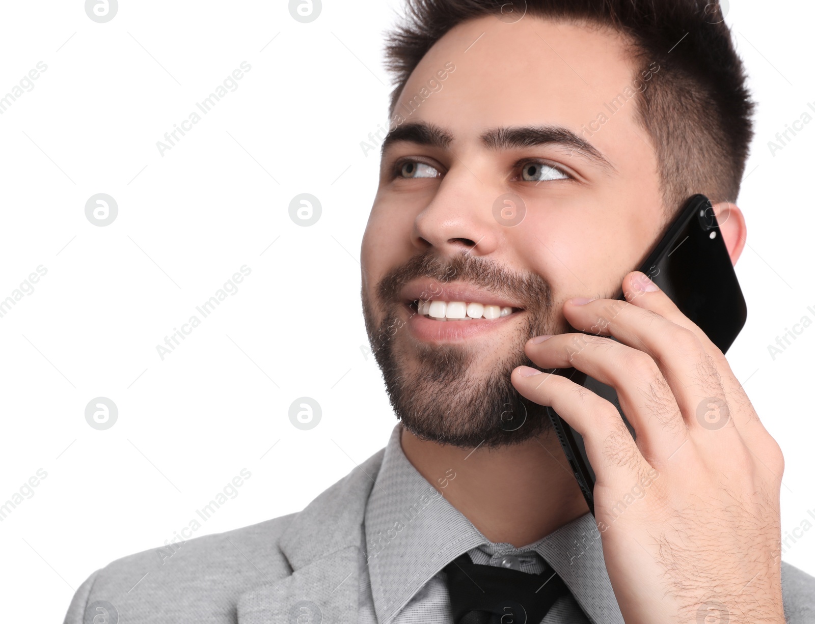 Photo of Young businessman talking on smartphone against white background