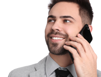 Young businessman talking on smartphone against white background
