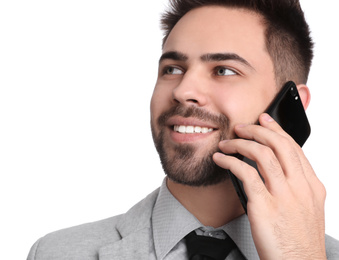 Photo of Young businessman talking on smartphone against white background