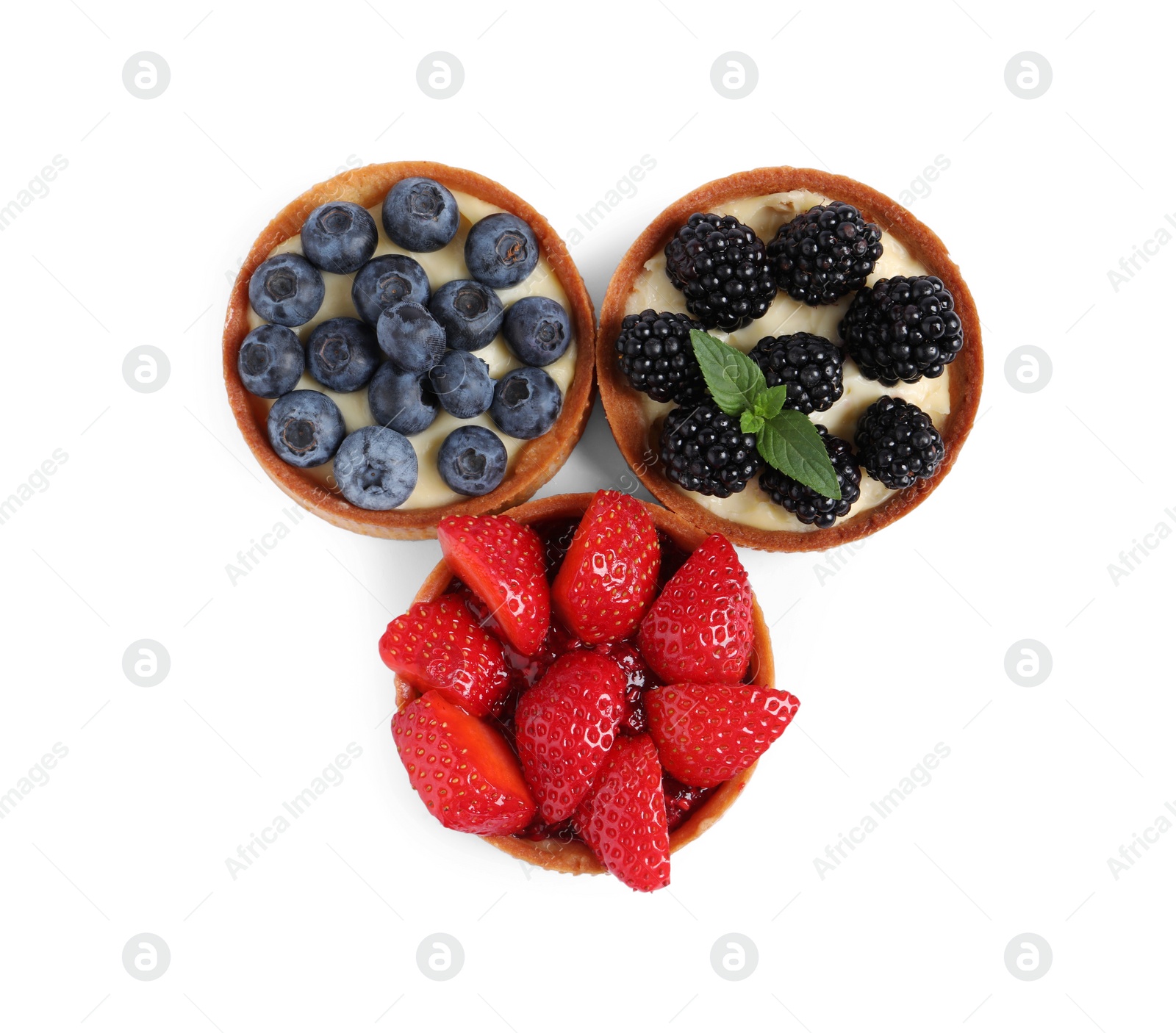 Photo of Tartlets with different fresh berries isolated on white, top view. Delicious dessert