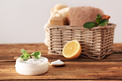 Photo of Jar with body care cream on wooden table