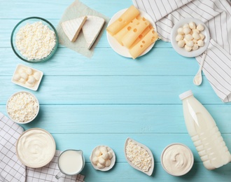 Flat lay composition with different dairy products on wooden background