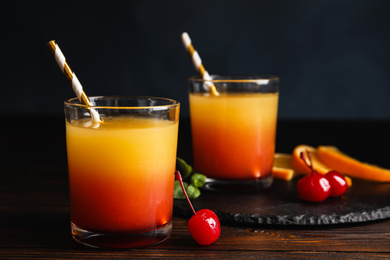 Photo of Fresh alcoholic Tequila Sunrise cocktail on wooden table