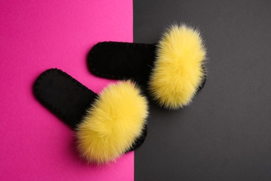 Photo of Pair of soft slippers on color background, flat lay