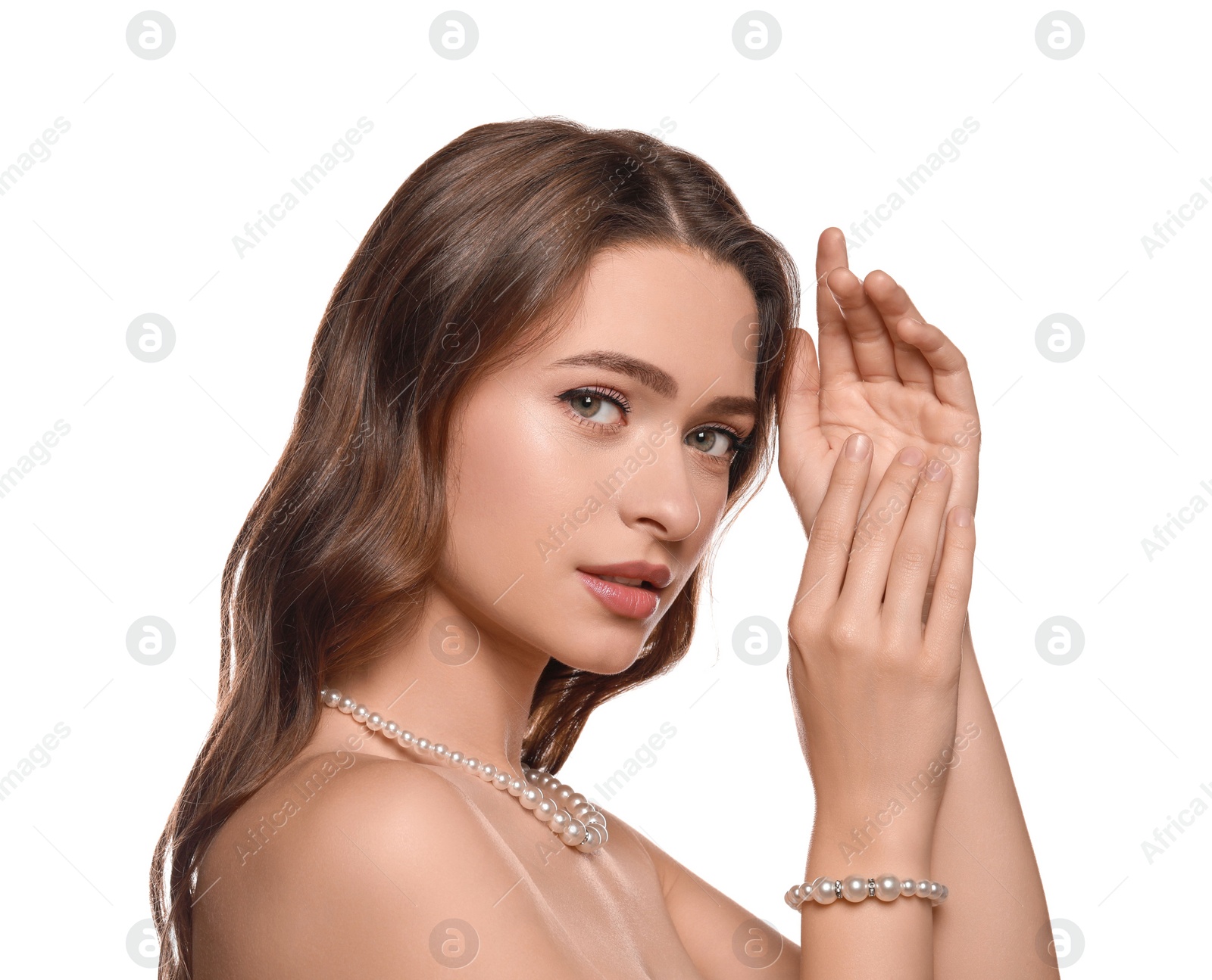 Photo of Young woman wearing elegant pearl jewelry on white background