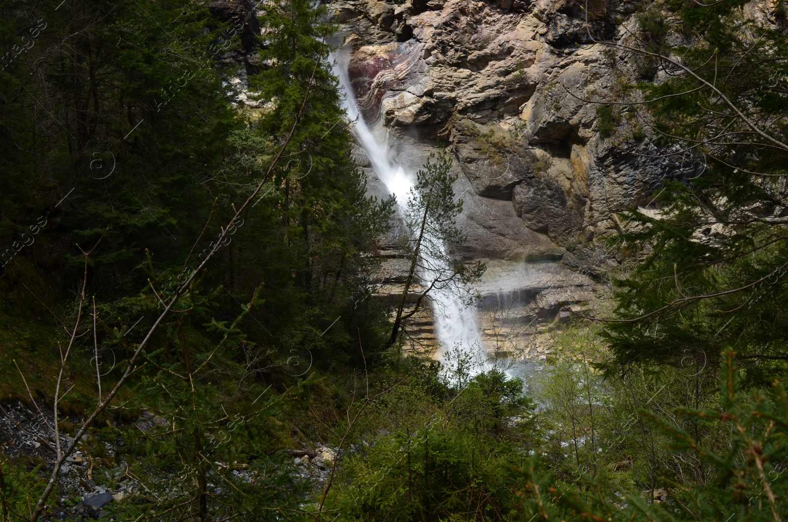 Photo of Picturesque view of beautiful mountain waterfall and rocks outdoors