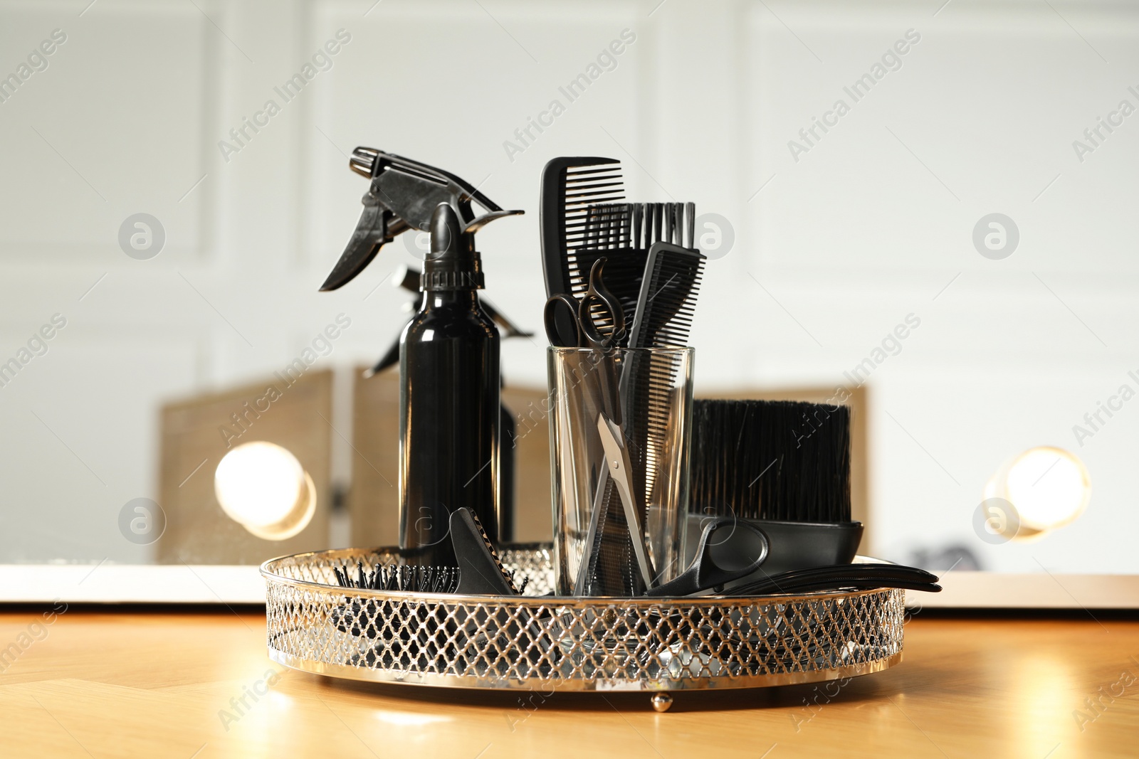 Photo of Set of hairdresser tools on table in salon