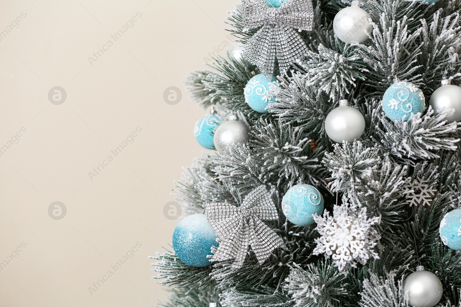 Photo of Beautiful Christmas tree with decor against light background. Space for text