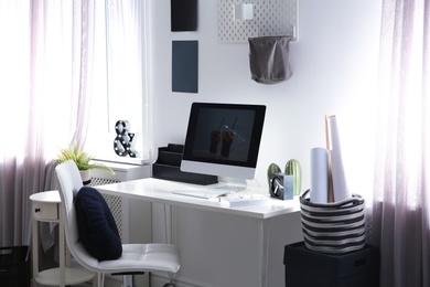 Photo of Comfortable workplace with computer on desk in home office