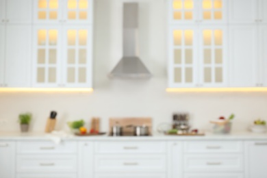 Photo of Blurred view of modern kitchen interior with stylish furniture