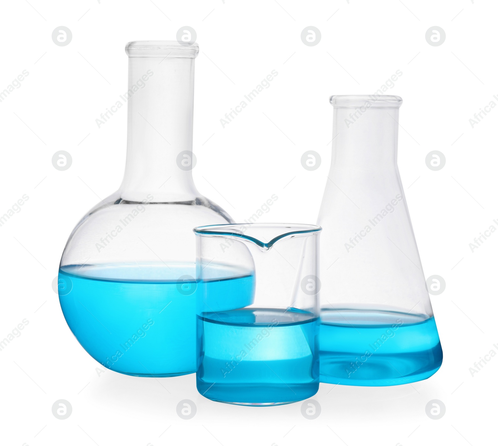 Photo of Different laboratory glassware with light blue liquid on white background