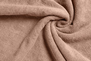 Photo of Soft crumpled brown towel as background, top view