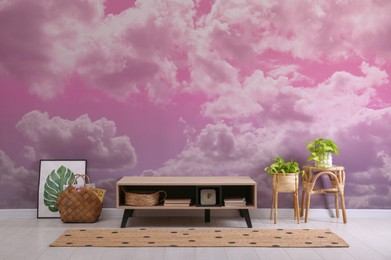 Image of Pink sky with clouds on wallpaper in furnished room. Beautiful interior design