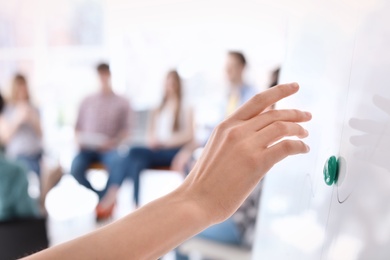 Female business trainer giving lecture in office, closeup