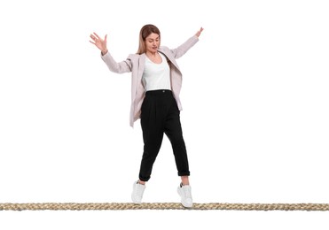 Image of Businesswoman walking rope against white background. Risk or balance concept