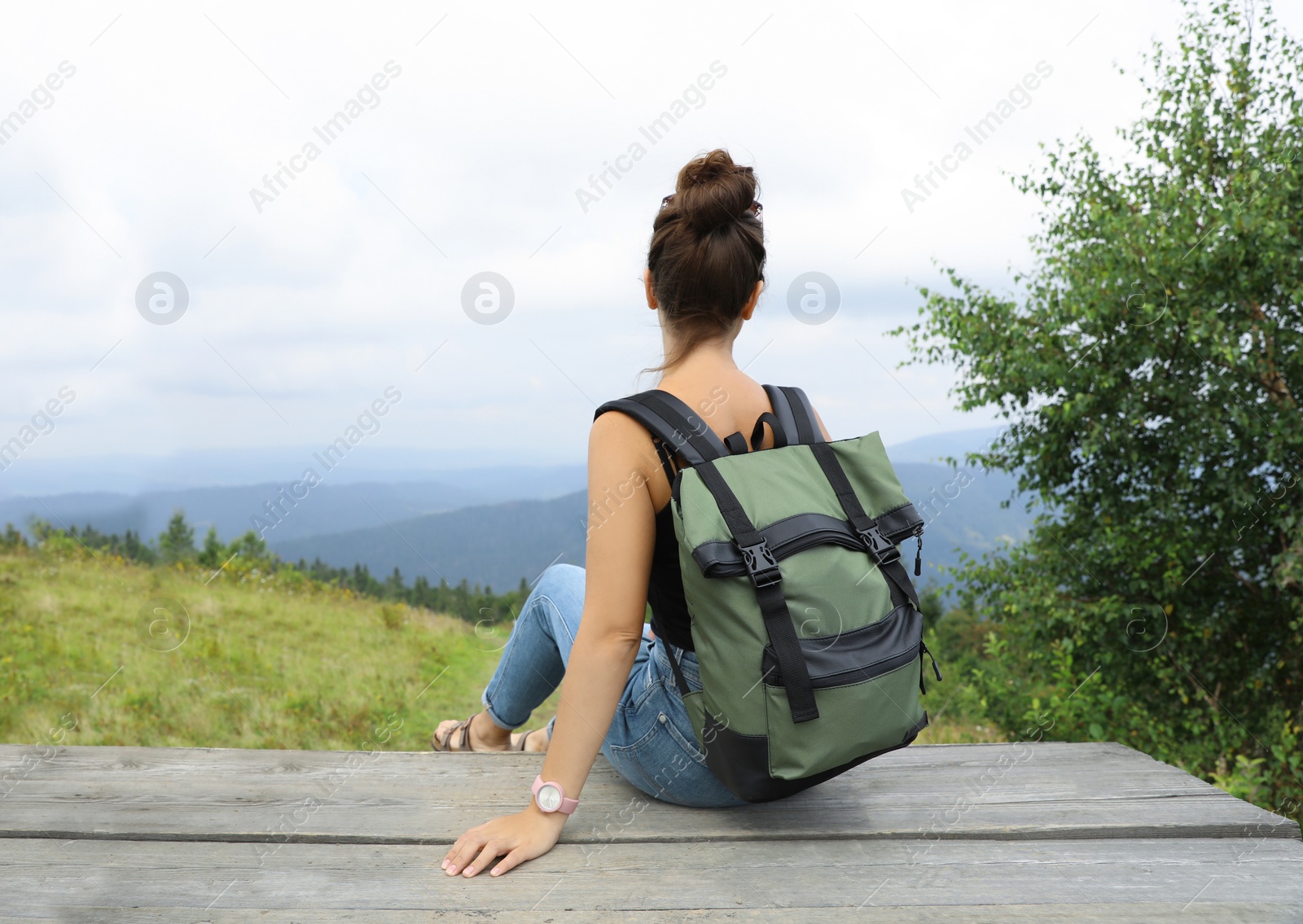 Photo of Woman with backpack in wilderness on cloudy day