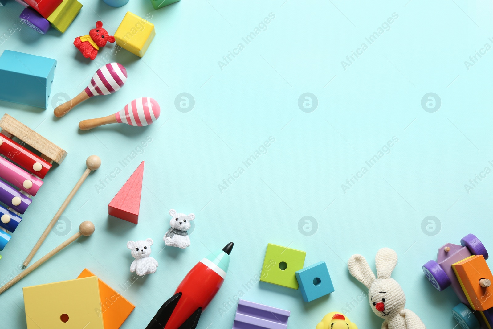 Photo of Flat lay composition with different toys on light blue background. Space for text