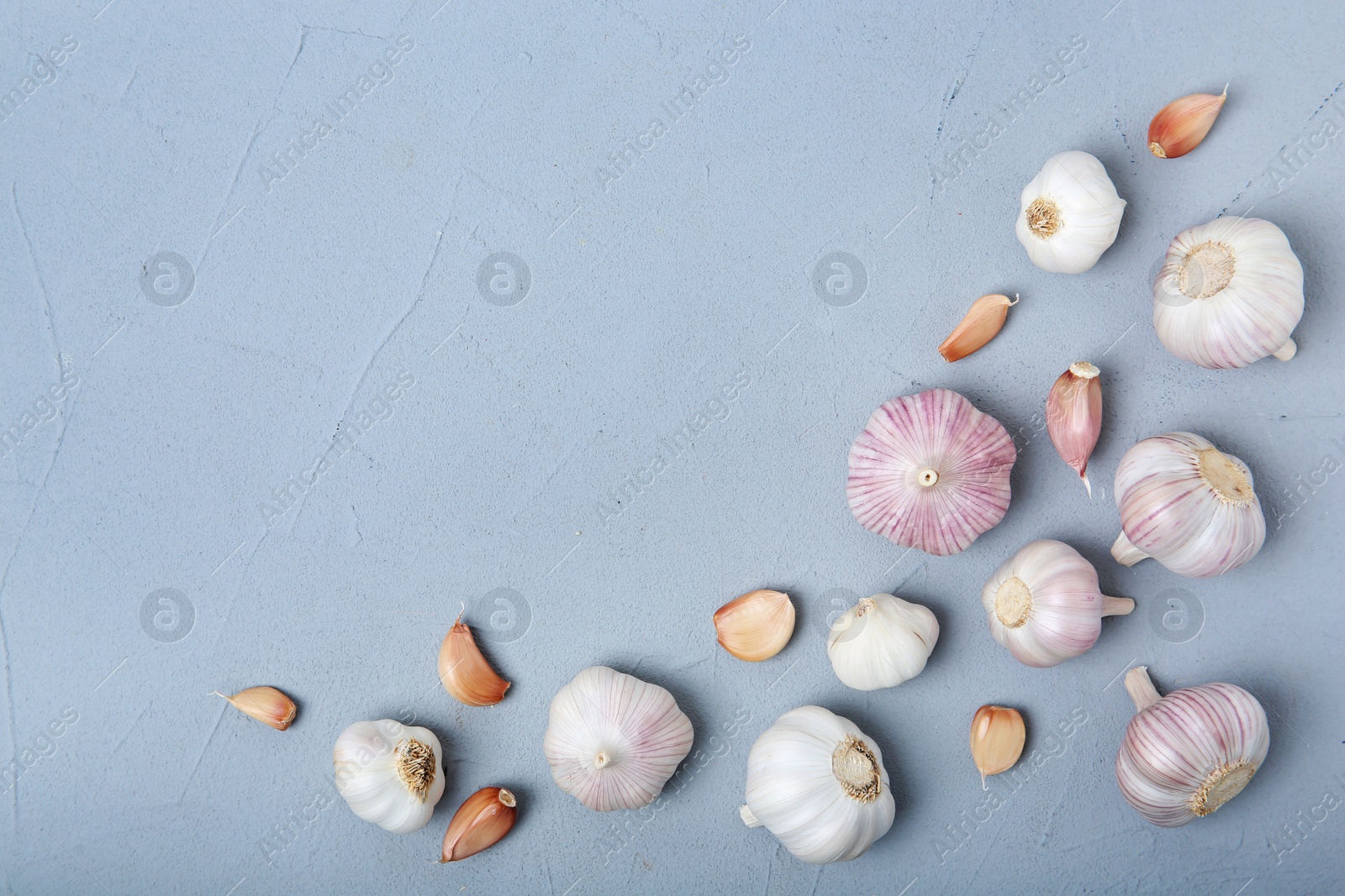 Photo of Flat lay composition with fresh garlic bulbs and cloves on gray background