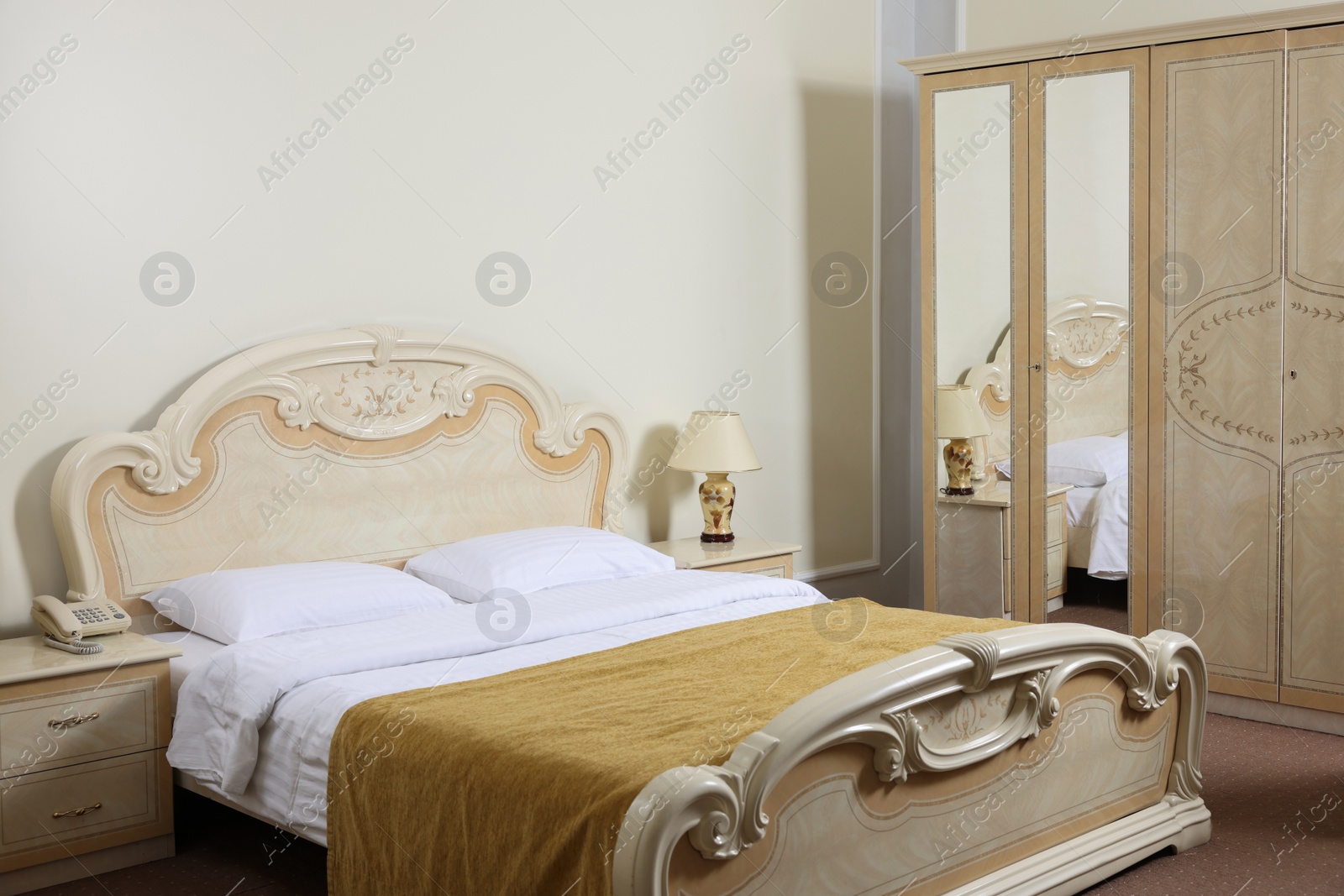 Photo of Modern bedroom with comfortable bed and wardrobe. Stylish interior