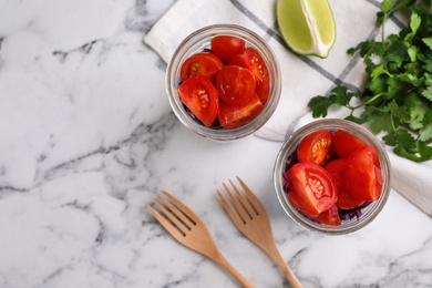 Healthy salad in glass jars on marble table, flat lay