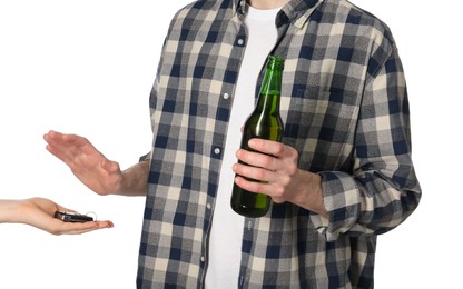 Photo of Man with bottle of beer refusing drive car while woman suggesting him keys on white background, closeup. Don't drink and drive concept
