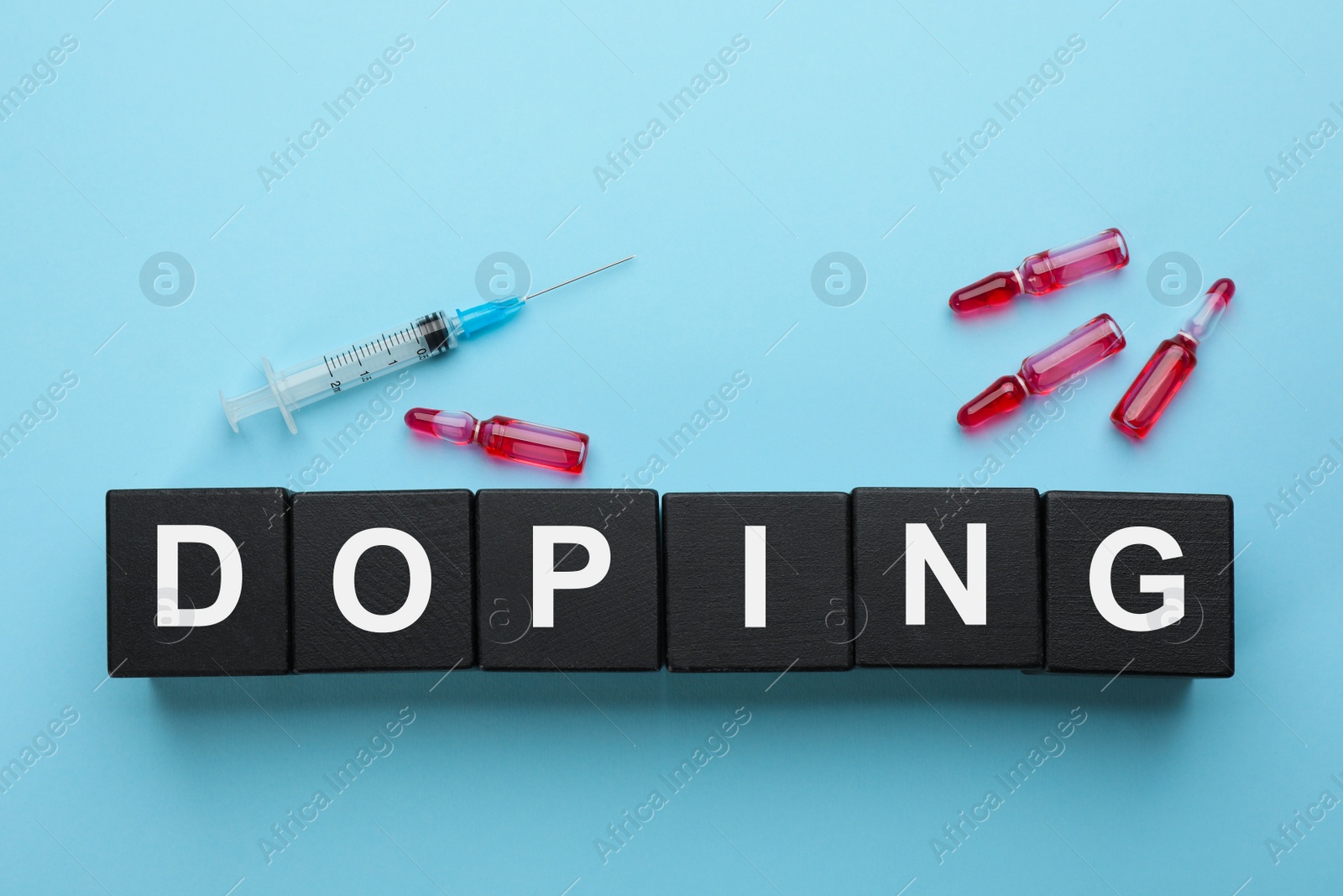 Photo of Black wooden cubes with word Doping and drugs on turquoise background, flat lay