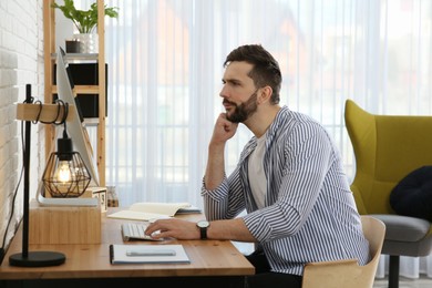 Photo of Online test. Man studying with computer at home