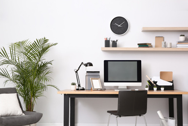 Modern computer on table in office interior. Stylish workplace