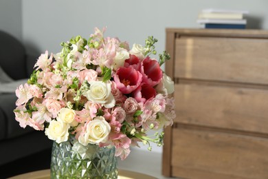 Photo of Beautiful bouquet of fresh flowers on table in room, space for text