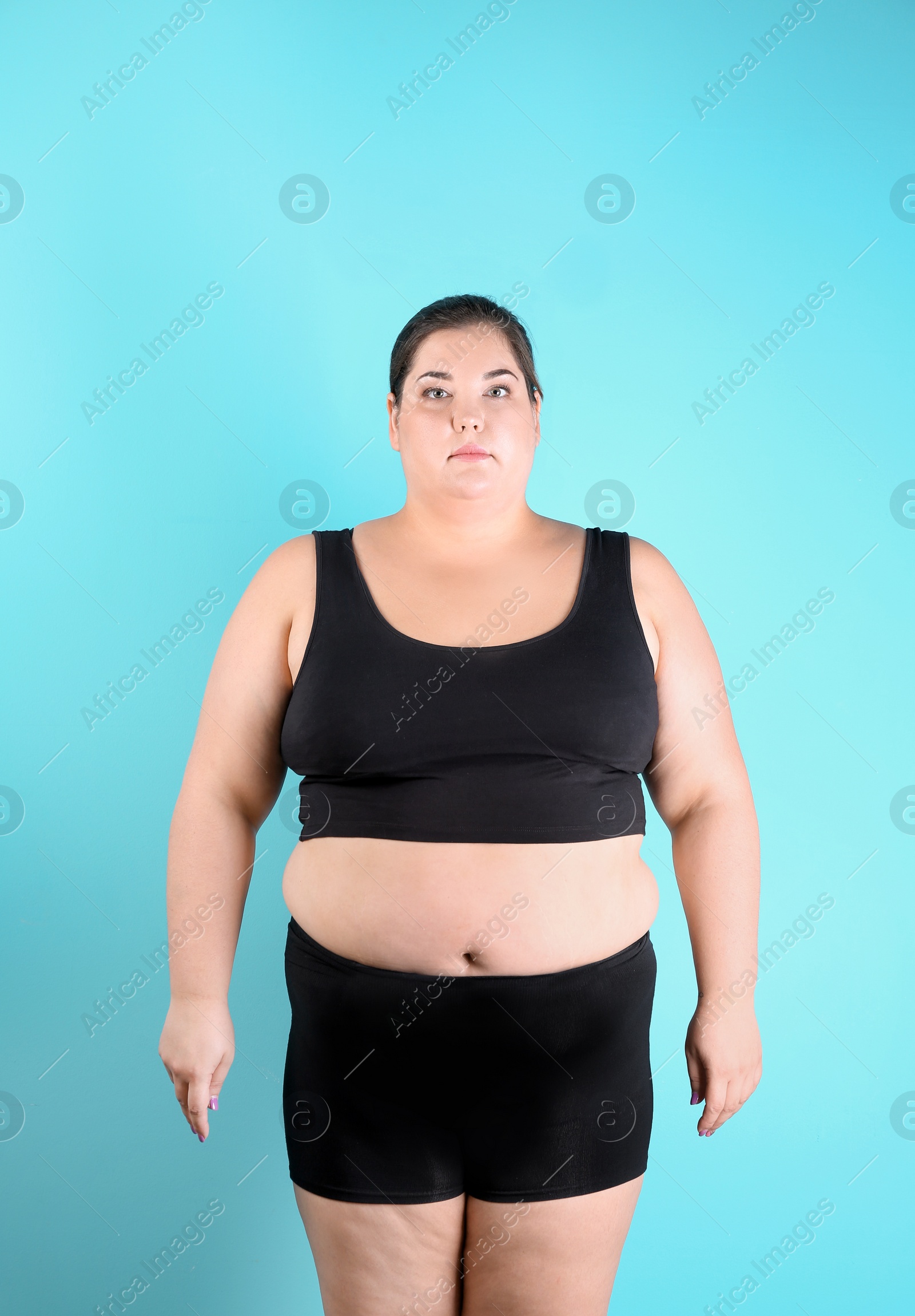 Photo of Overweight woman before weight loss on color background