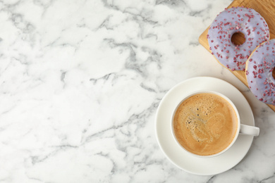 Delicious pastries and coffee on marble table, flat lay. Space for text