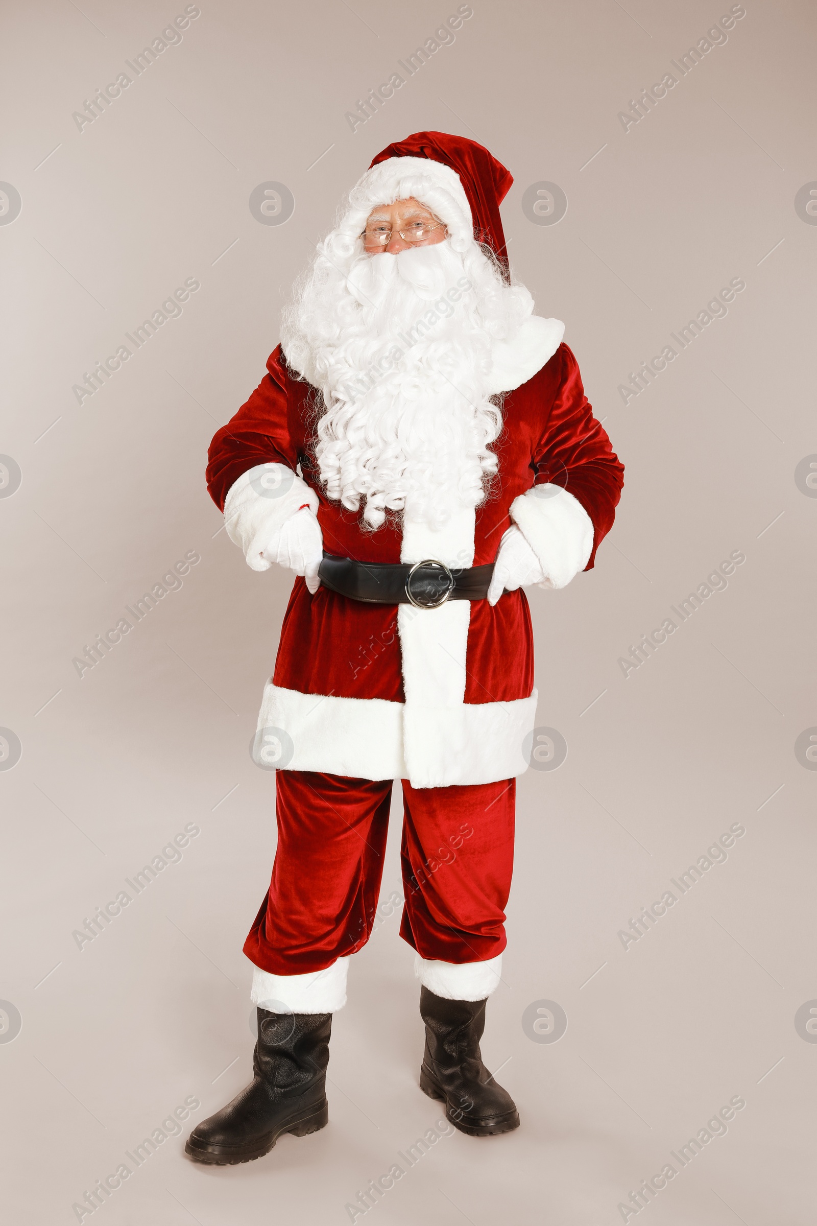 Photo of Happy authentic Santa Claus on grey background