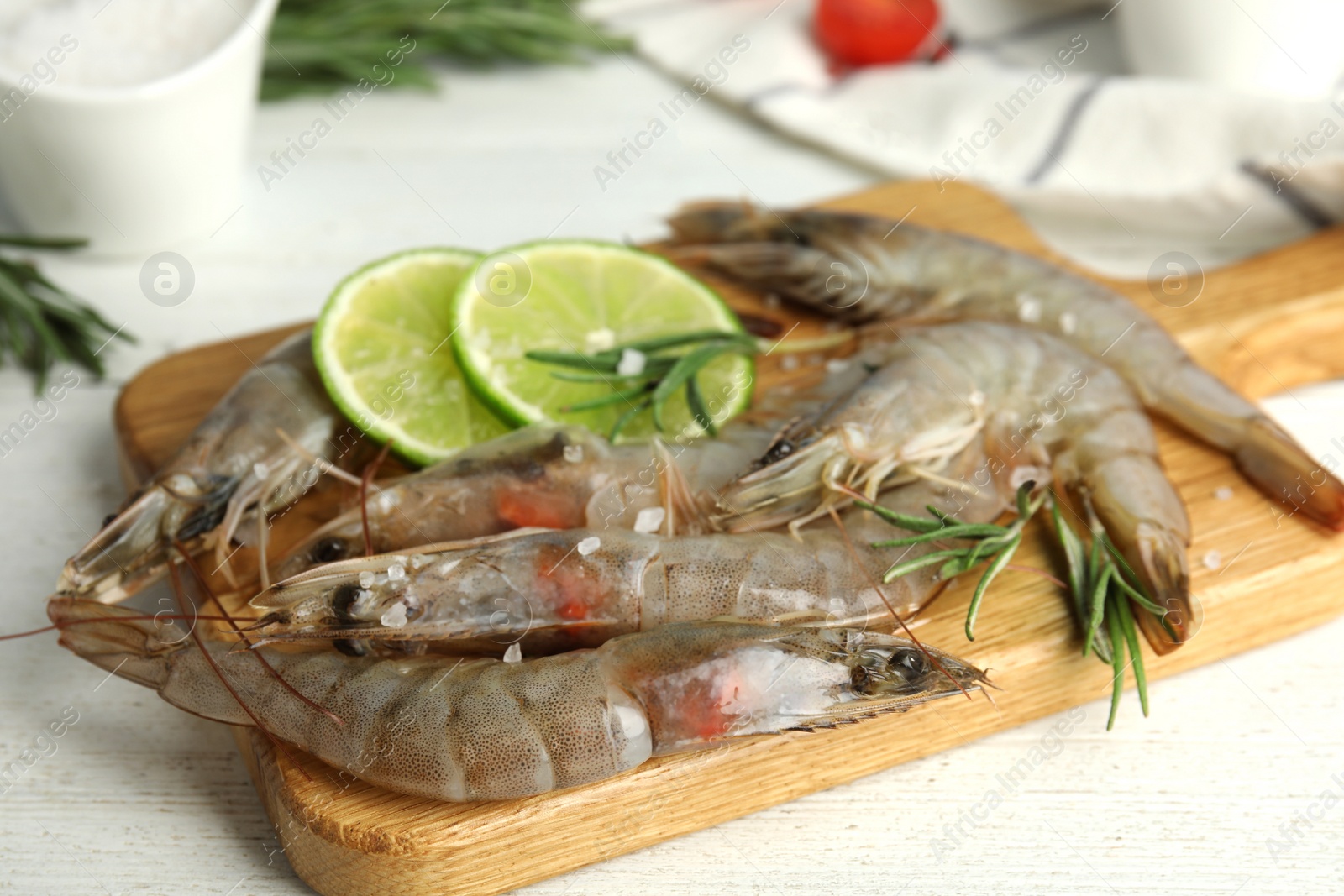 Photo of Fresh raw shrimps on white wooden table