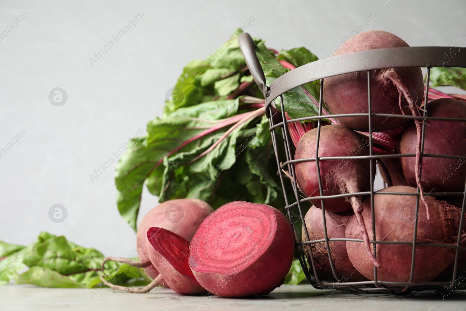 Photo of Fresh ripe beets on light grey table